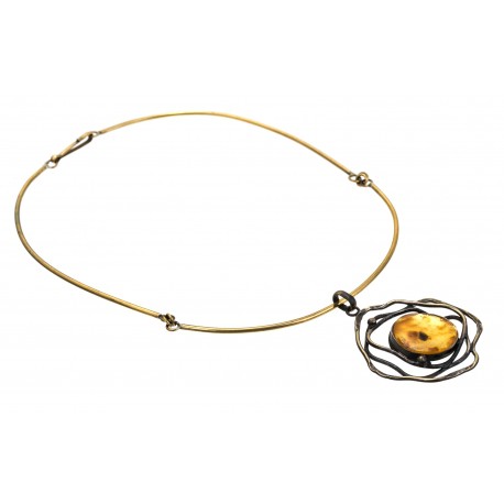 Brass necklace decorated with tracery ornaments and a clear lemon amber 