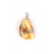Massive amber pendant decorated with silver flowers